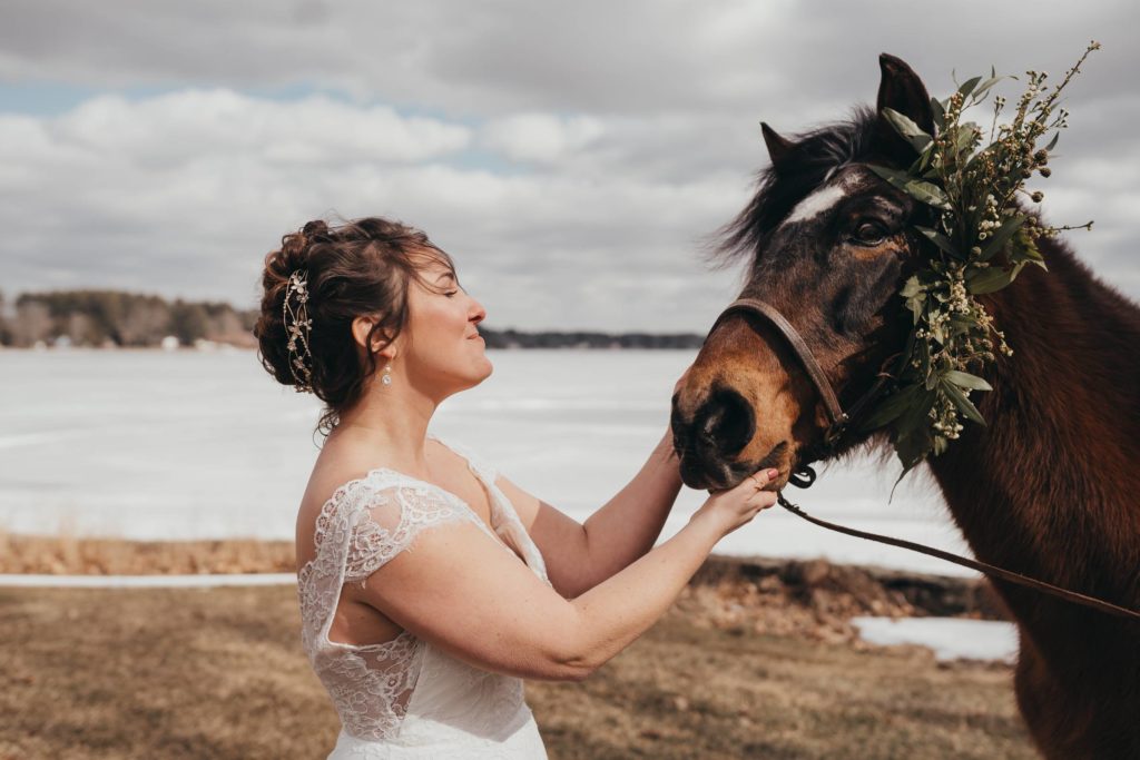 Bride gently pets a horse