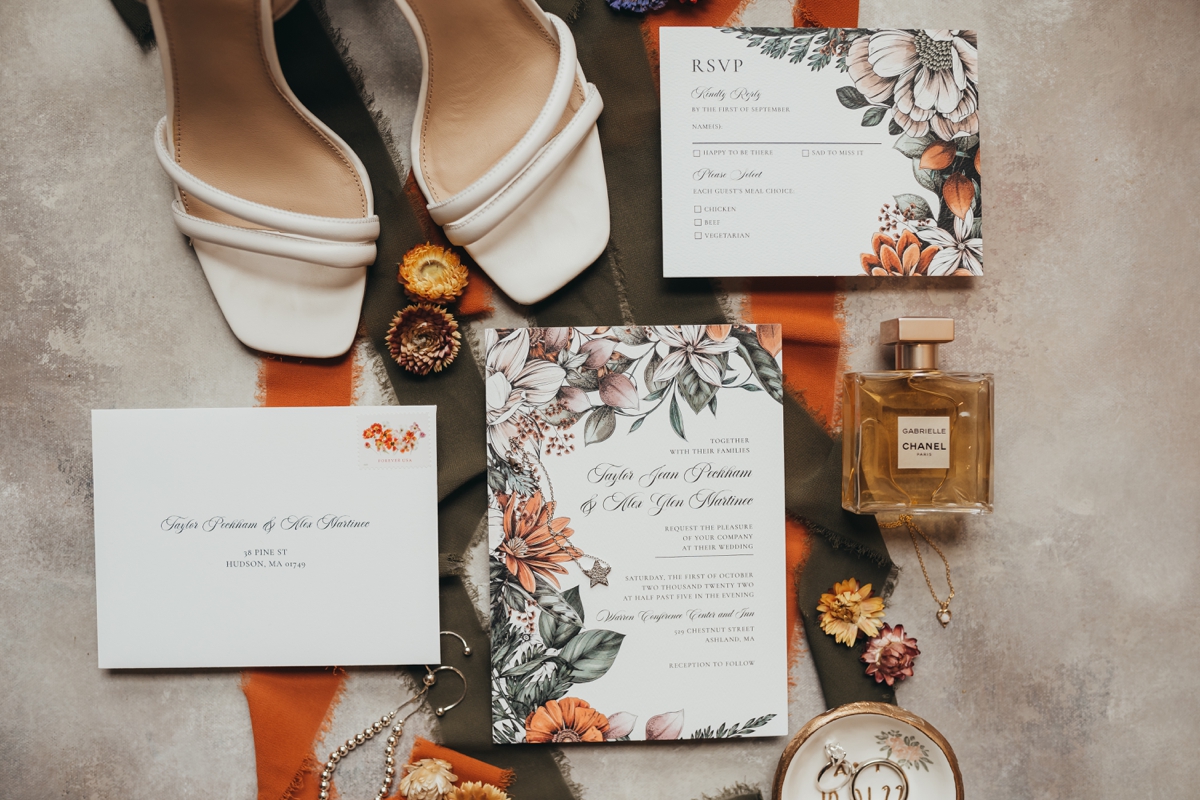 a photo of orange and green floral wedding details