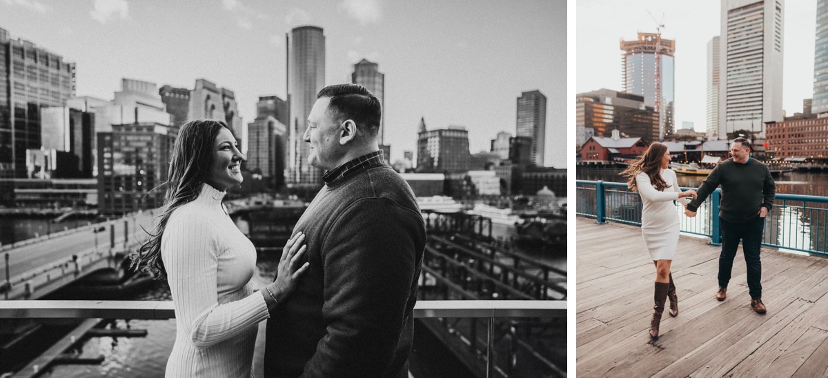 A couple standing smiling at one another with the Boston skyline in the background.