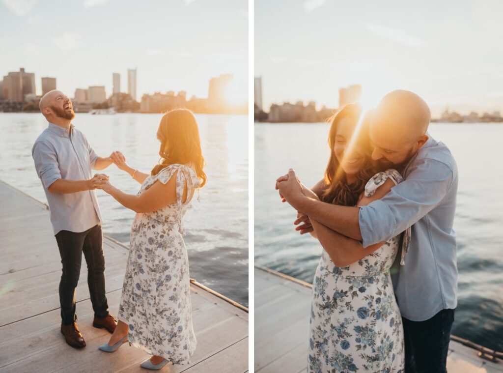 A couple dancing on a dock, with the sun and the Boston skyline behind them.