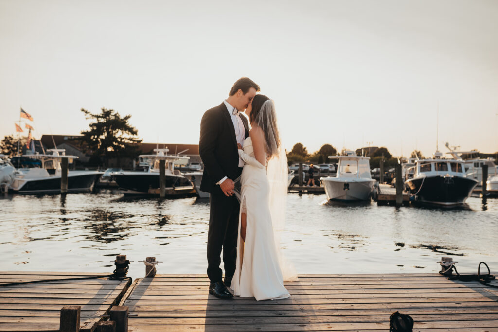 Couple kissing on dock during sunset in Newport Rhode Island