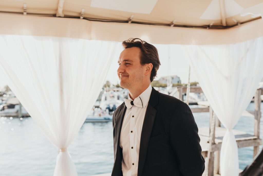Groom waits at the top of the aisle at Regatta Place in Newport Rhode Island